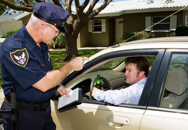 Do You Need a Lawyer for an Open Container Law in California? 1 A man driving with a beer getting a ticket for violating California state open container laws.