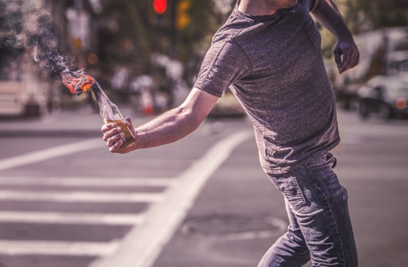 What is Looting Under California Law? 1 A man preparing to throw a molotov cocktail used to illustrate looting laws in California