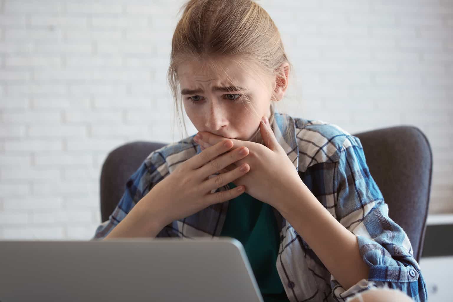 What You Should Know About the Revenge Porn Law in California 1 A shocked, worried young girl looks at a computer with her hand over her mouth