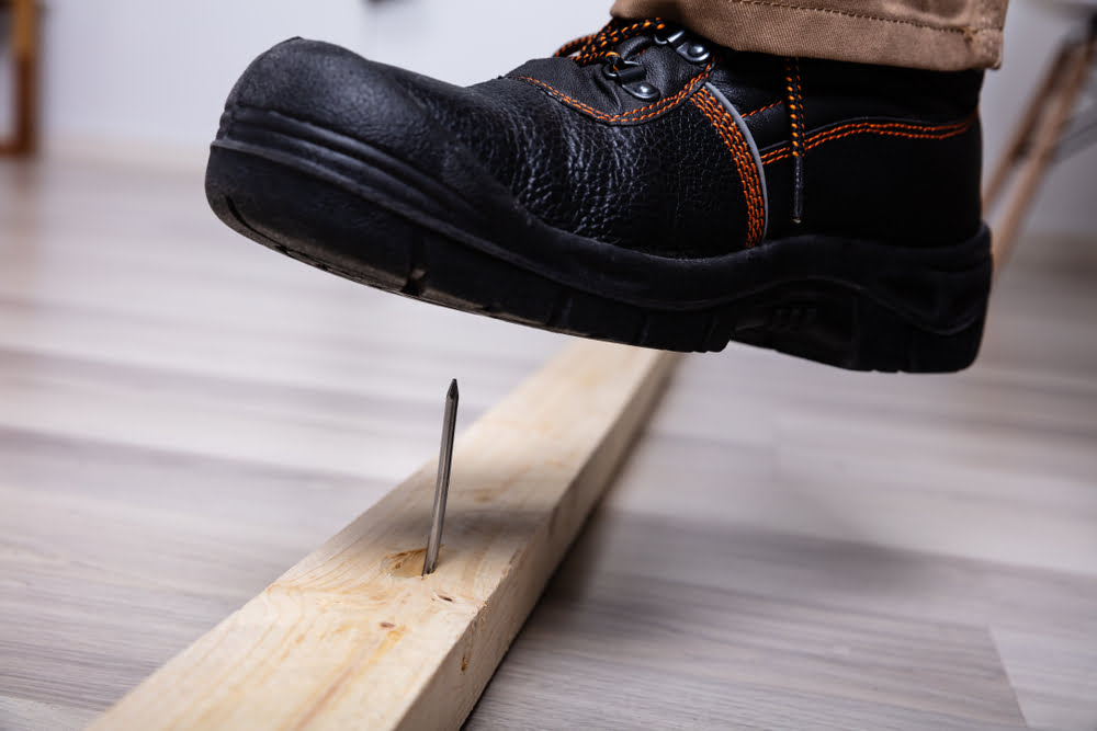Fighting Workers' Compensation Fraud Charges in Vista: 1871.4 (CIC) 1 A leather boot hovering over a nail to illustrate worker's compensation fraud