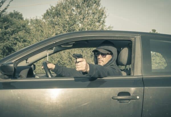 Hit and Run Accident Lawyer Vista 4 A man aiming a gun out of his window would make it unsafe to stop after an accident.
