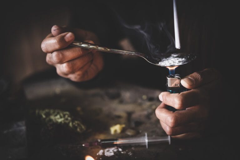 a person heating drugs in a spoon