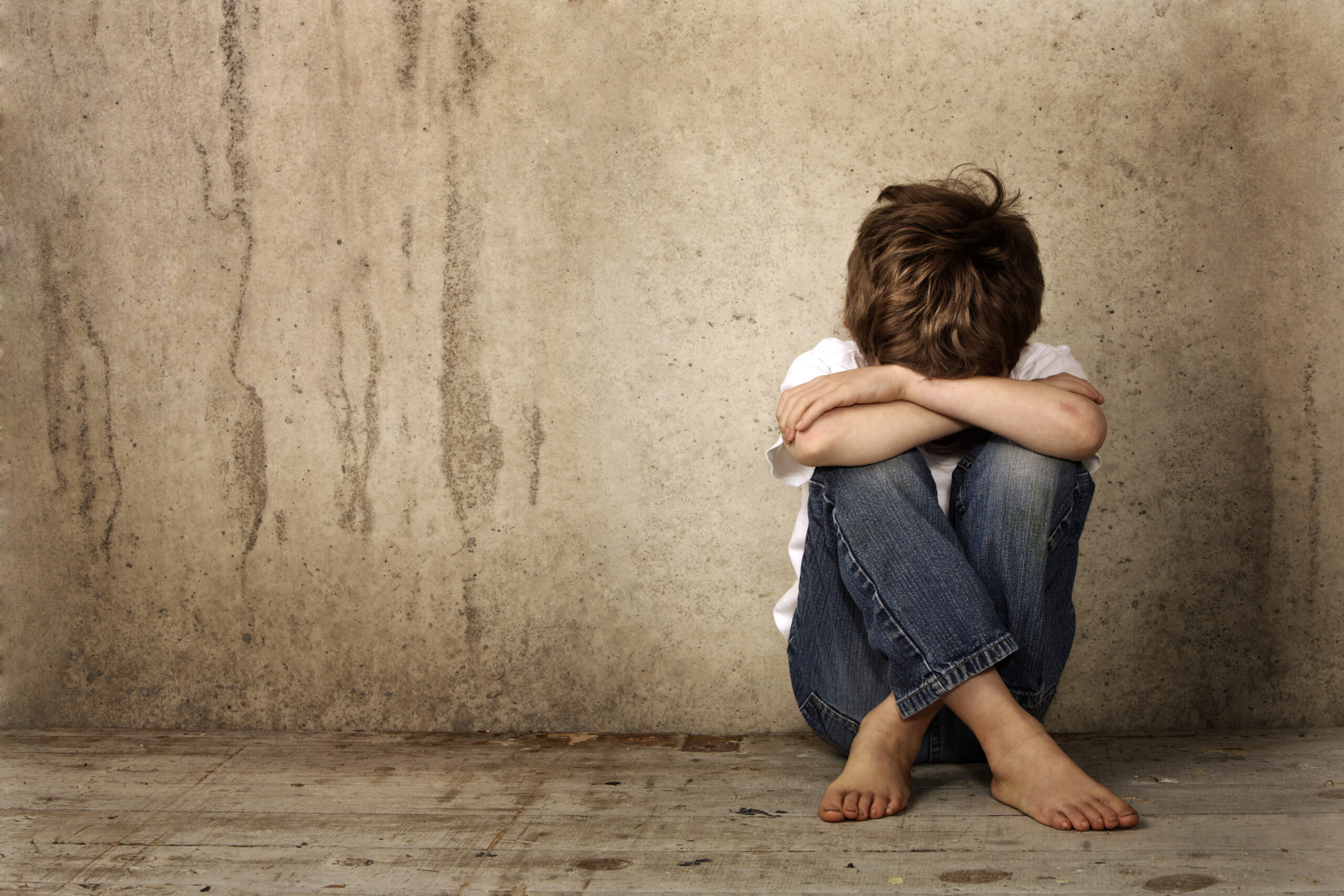 Vista Internet Sex Crime Defense Attorney 2 A young boy hides his face in his knees after being victimized by an internet sex crime