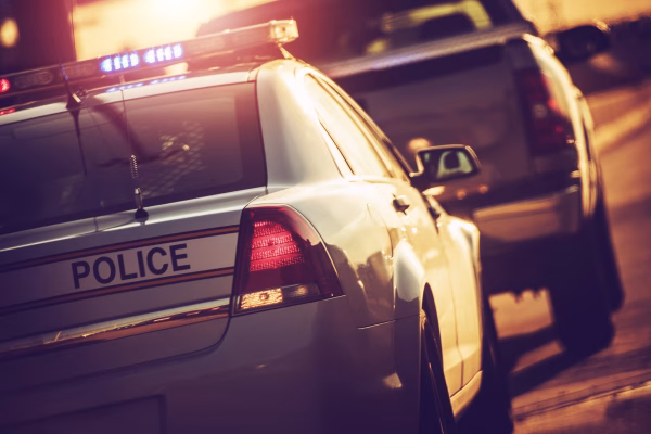 A police car stopping a truck to illustrate repeat DUI charges